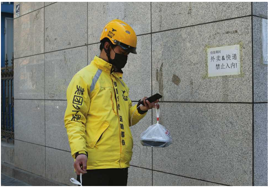 高治<em>曉</em>在寫字樓外等待取外賣的顧客